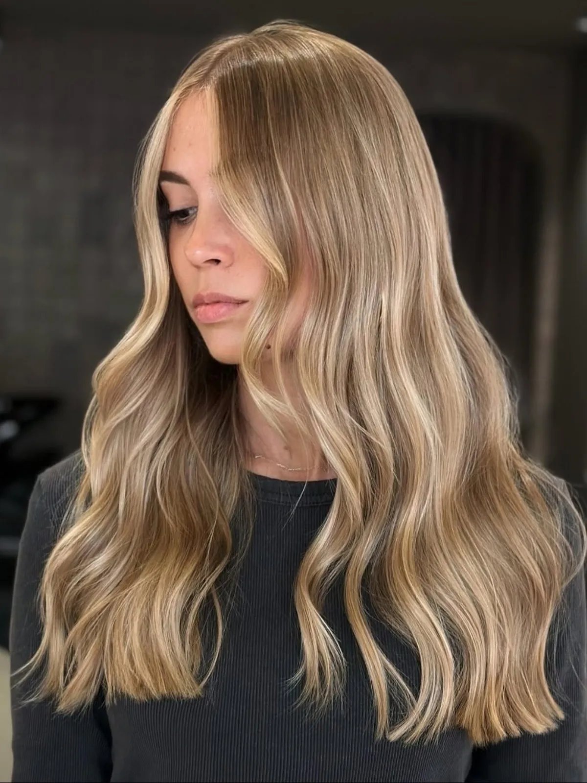 Model with long, blonde hair featuring multi-tonal highlights.