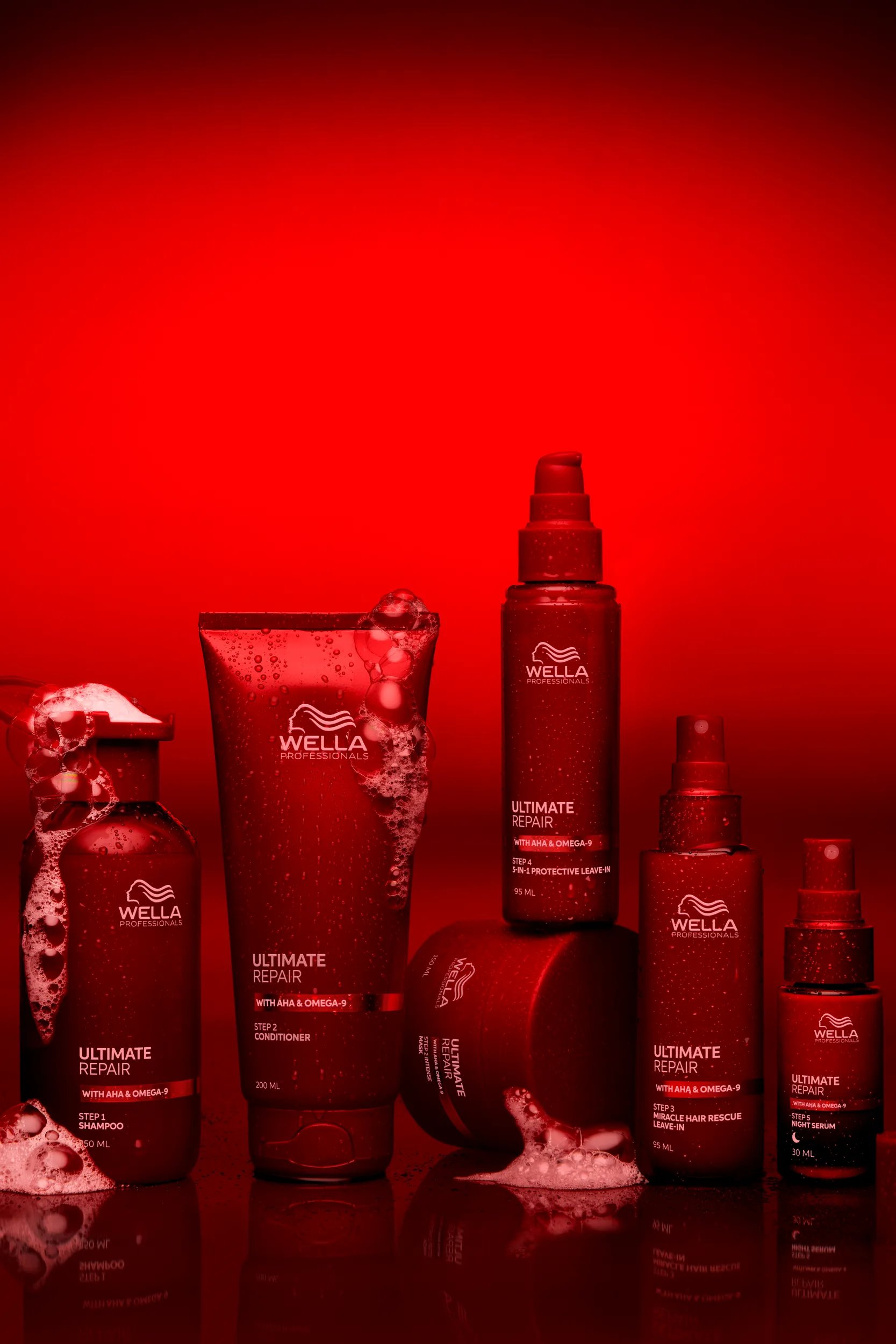ULTIMATE REPAIR Shampoo, Conditioner and Miracle Hair Rescue lined up in front of a red backdrop.