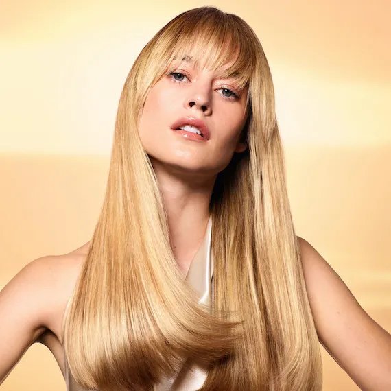 Model with long, blonde, straight, honey blonde hair.