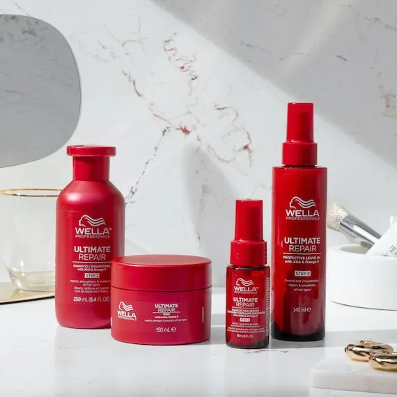 ULTIMATE REPAIR Shampoo, Mask, Miracle Hair Rescue and Protective Leave-In on a marble surface. 