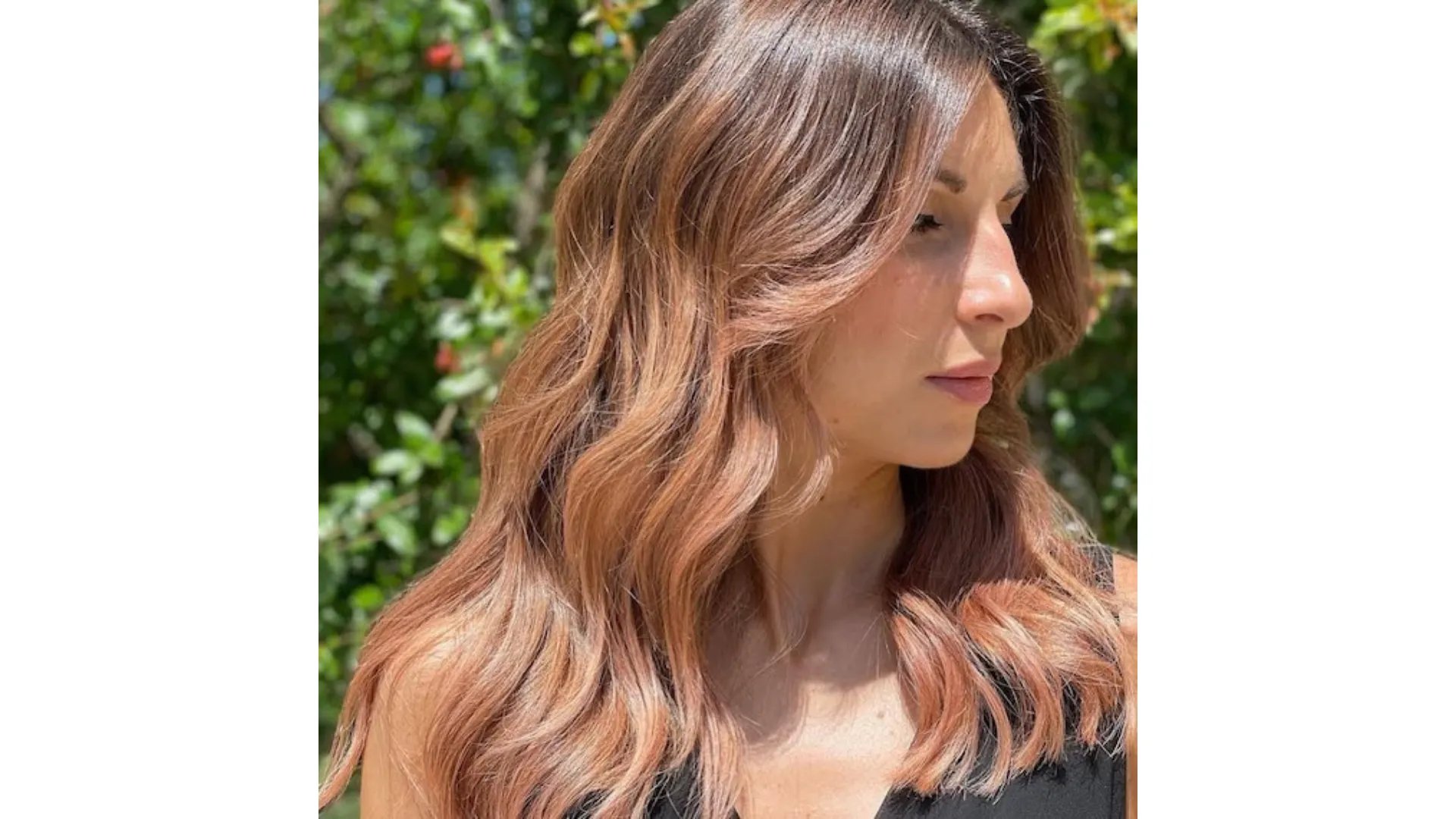 Model with dark brown hair and pinky-peach tones painted through the lengths.