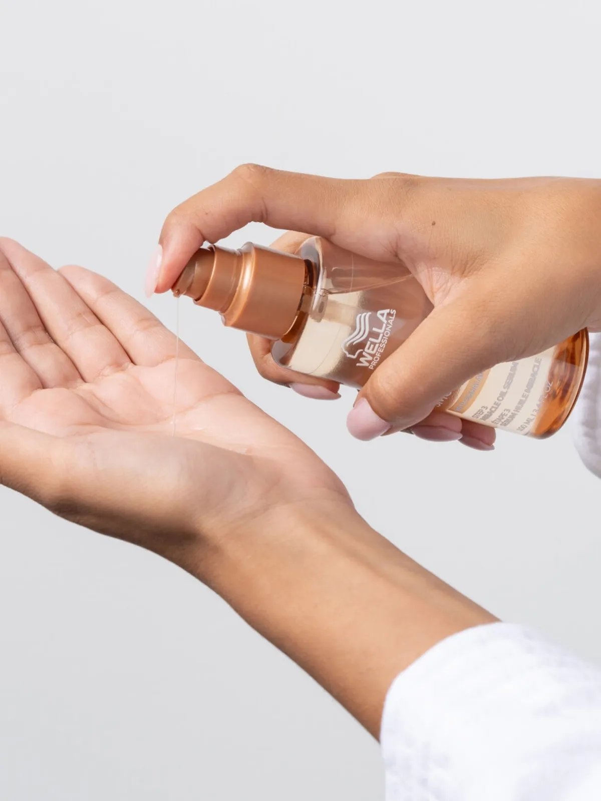 ULTIMATE SMOOTH Miracle Oil Serum pumped into palm of hand.