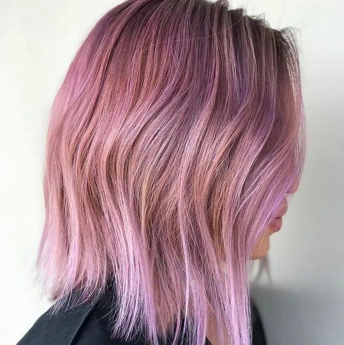 Side profile of woman with pink bob haircut, created using Wella Professionals.