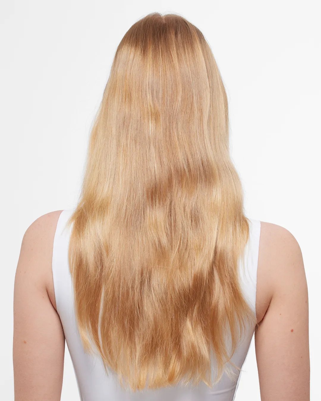 Back view of a woman with long, straight blonde hair wearing a white tank top.