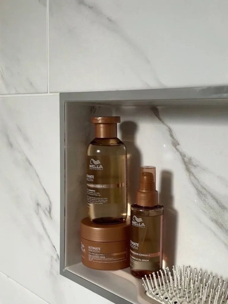 ULTIMATE SMOOTH Shampoo, Mask and Miracle Oil Serum in a marble bathroom.