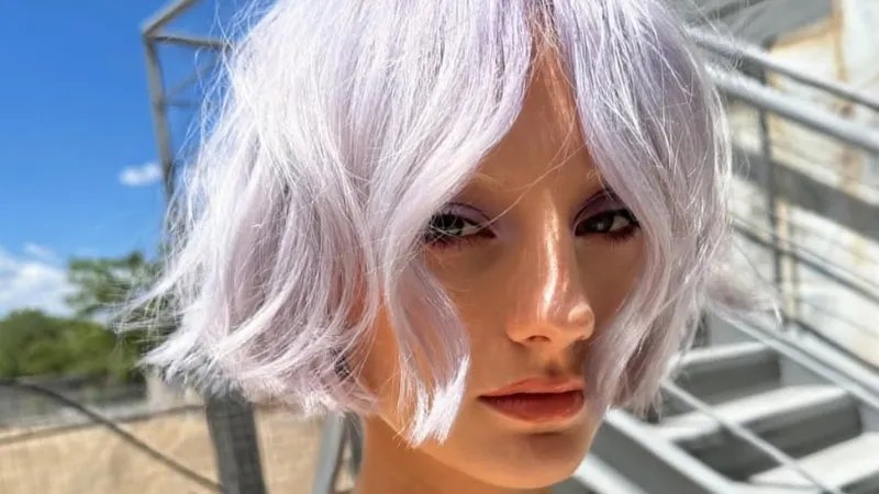 Model with pastel purple, chin-length bob haircut.