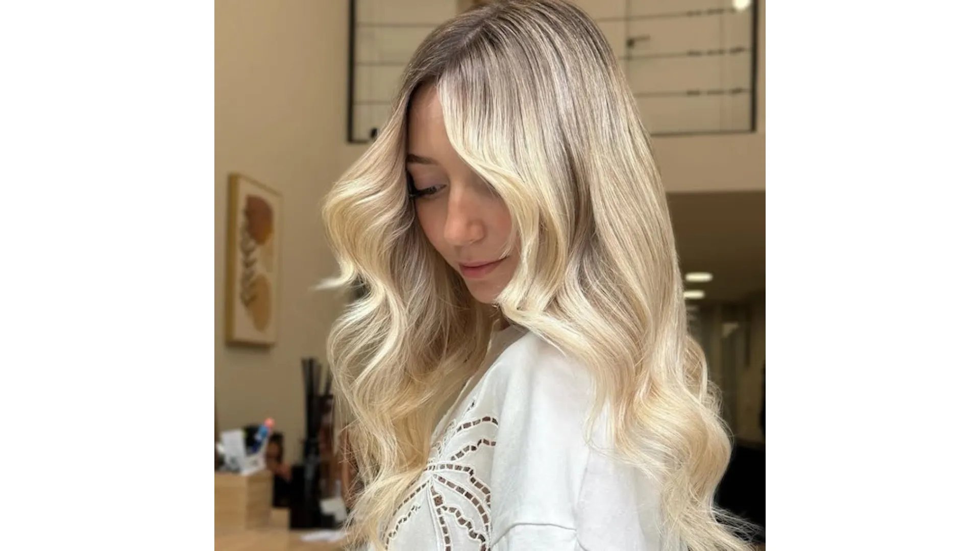 Model with long, loosely curled, blonde hair with an expensive-looking glow.
