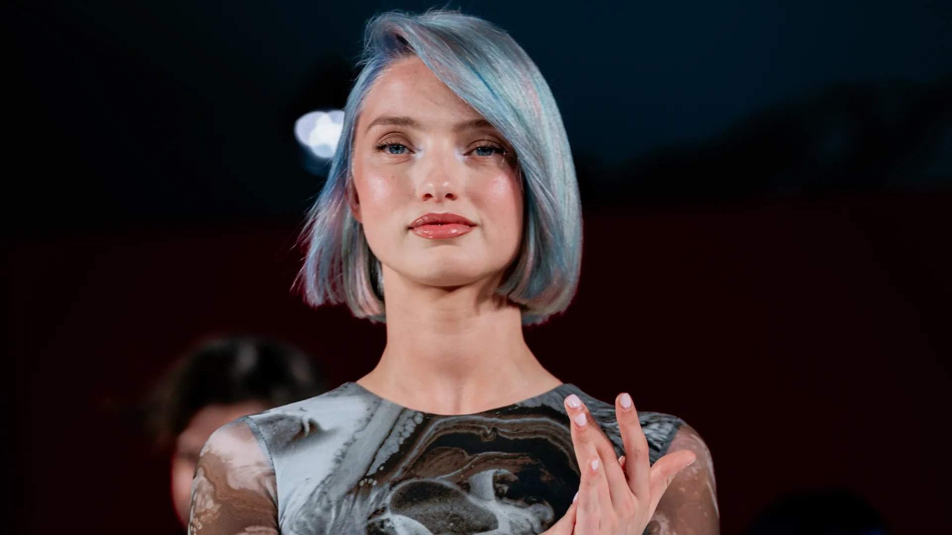 Model with a blonde bob featuring slices of petrol green, blue and purple.