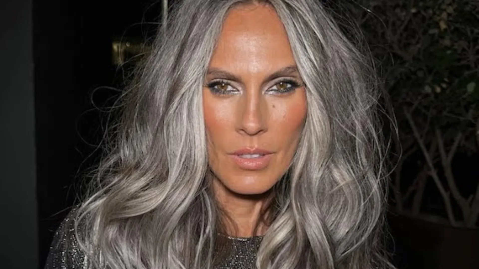 Model with long, tousled, silvery grey hair.