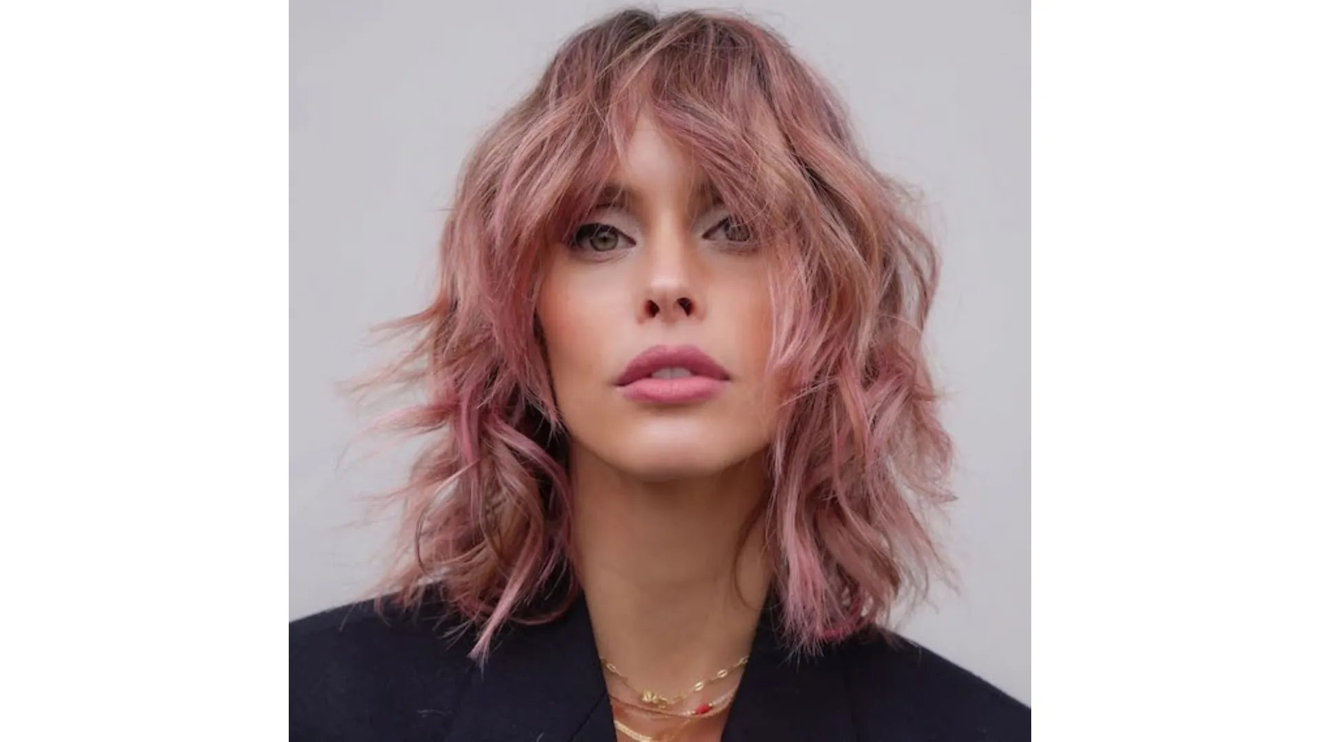 Model with shoulder-length shag haircut in a dusty pink shade.