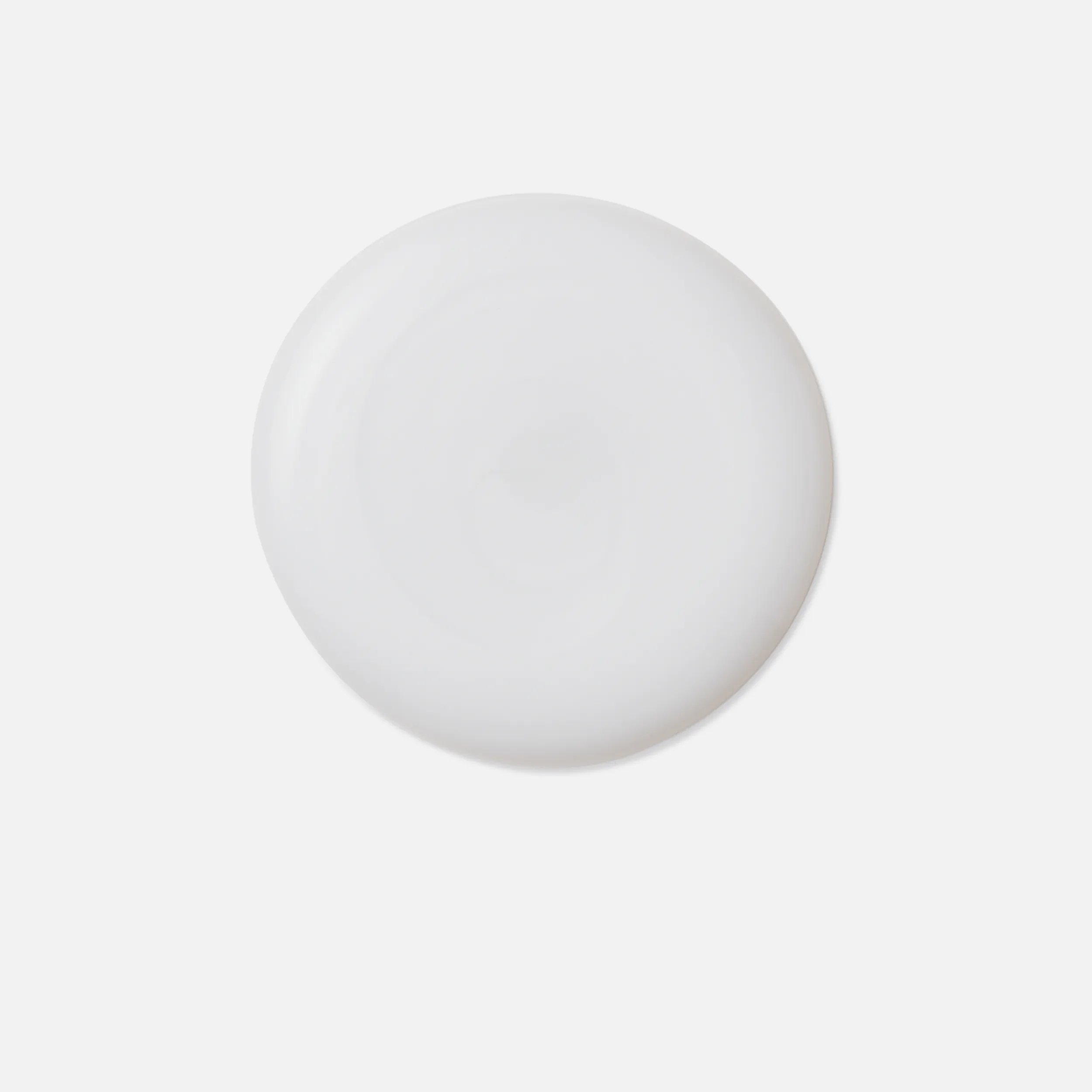 Close-up photograph of a circular blob of Fusion Intense Repair Shampoo product on a white background.