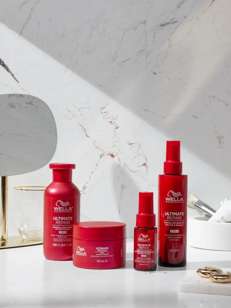 ULTIMATE REPAIR Shampoo, Mask, Miracle Hair Rescue and Protective Leave-In in a marble bathroom.