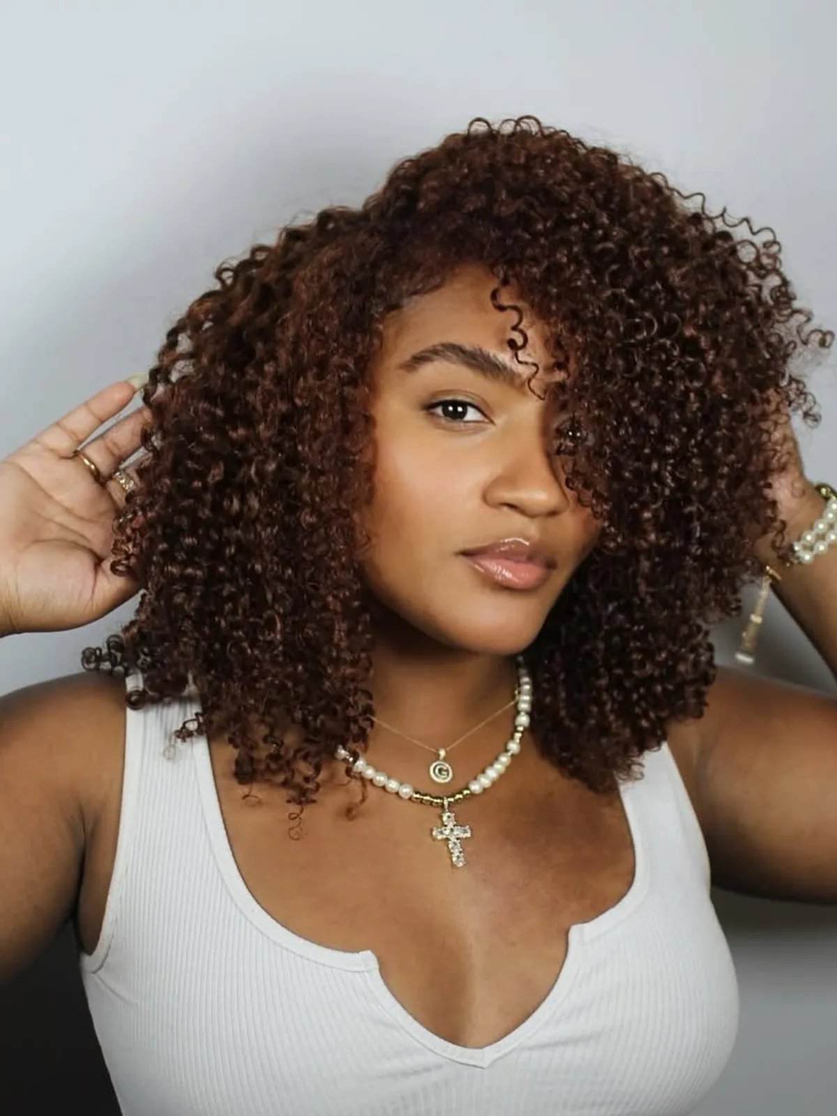Chocolate cherry hair color with a blend of red and brown tones for a warm, rich look.