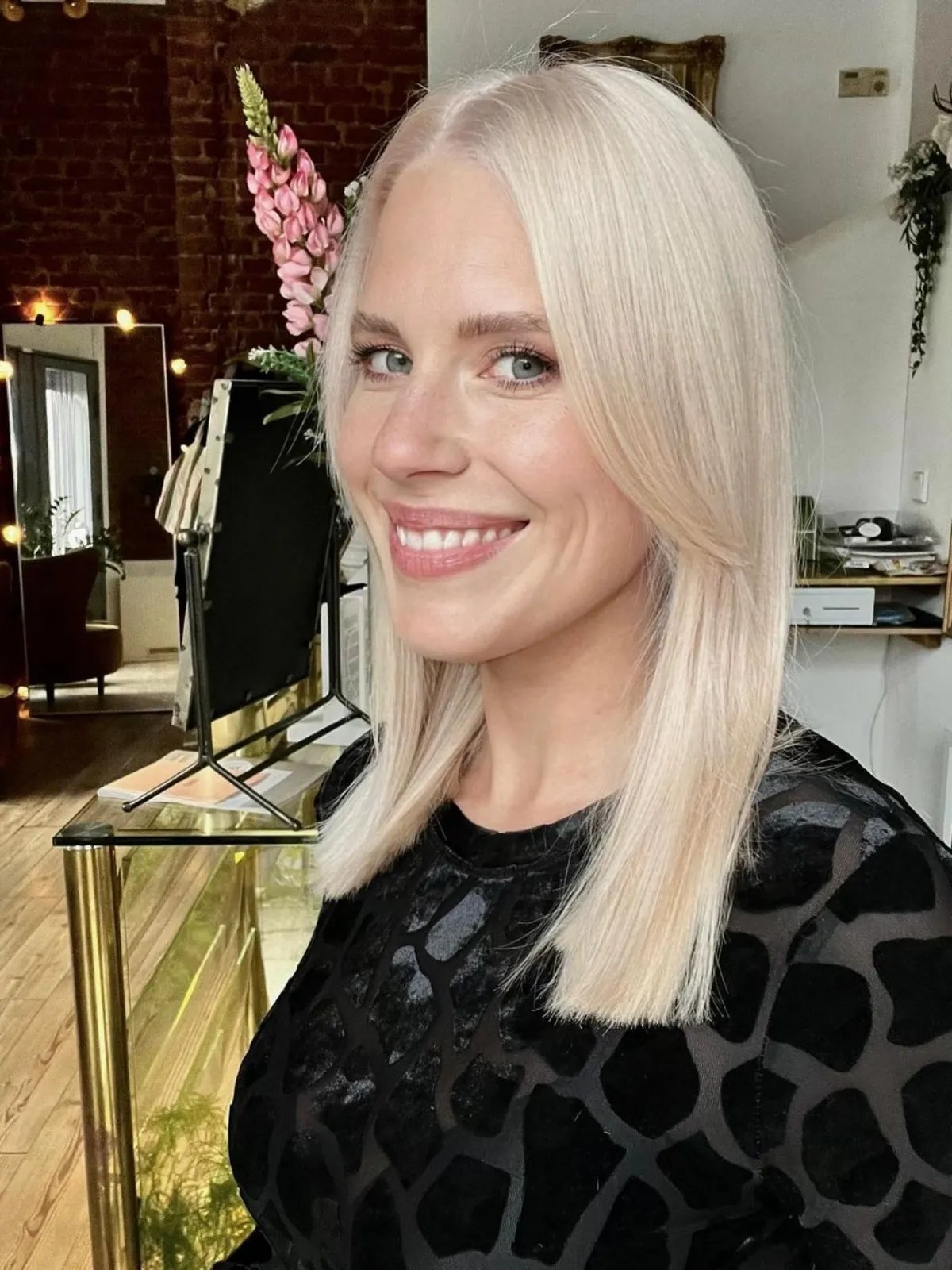 Model with mid-length, straight platinum blonde hair with a soft, neutral undertone.