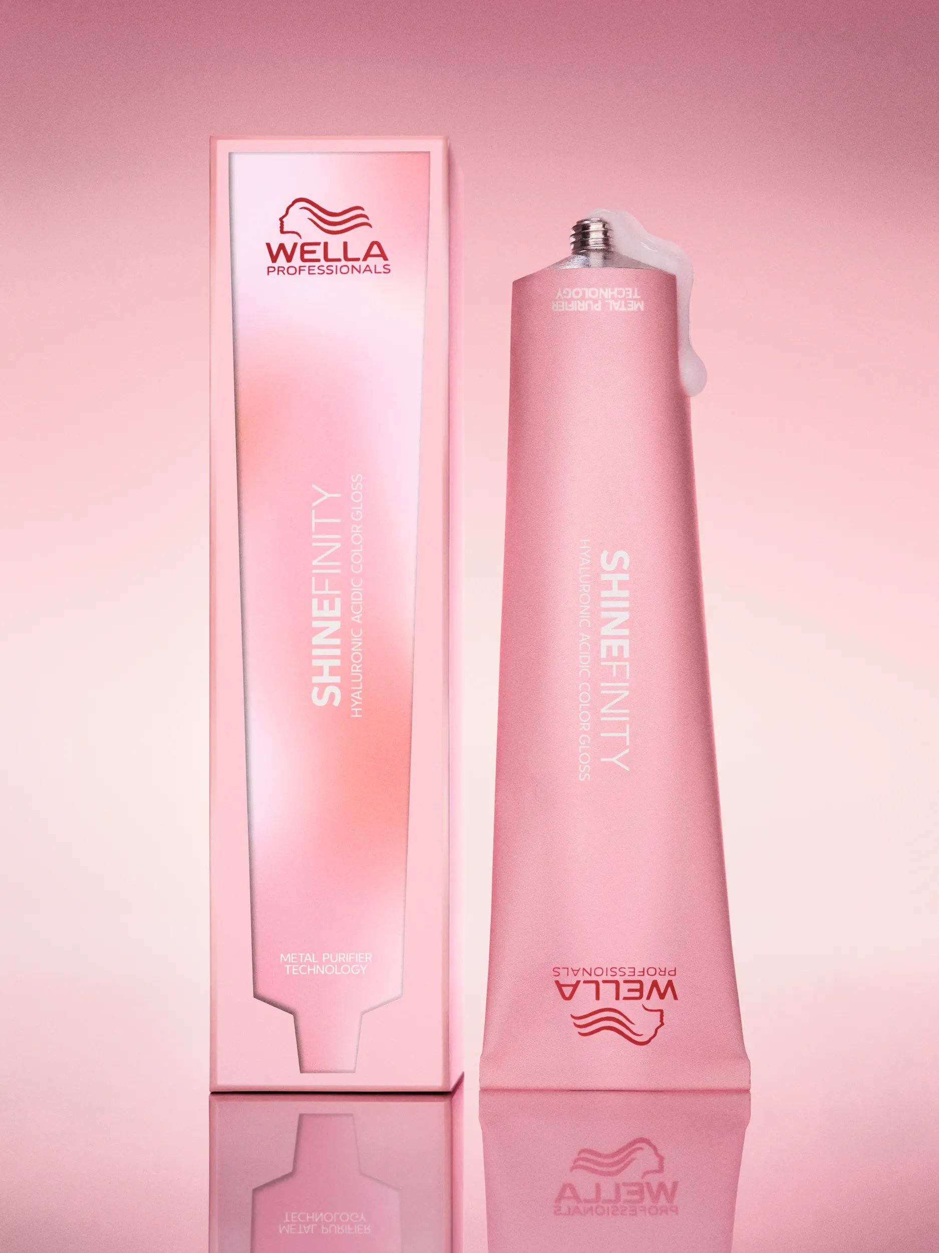 Model with short, brown, curly hair holding up a tube of SHINEFINITY.