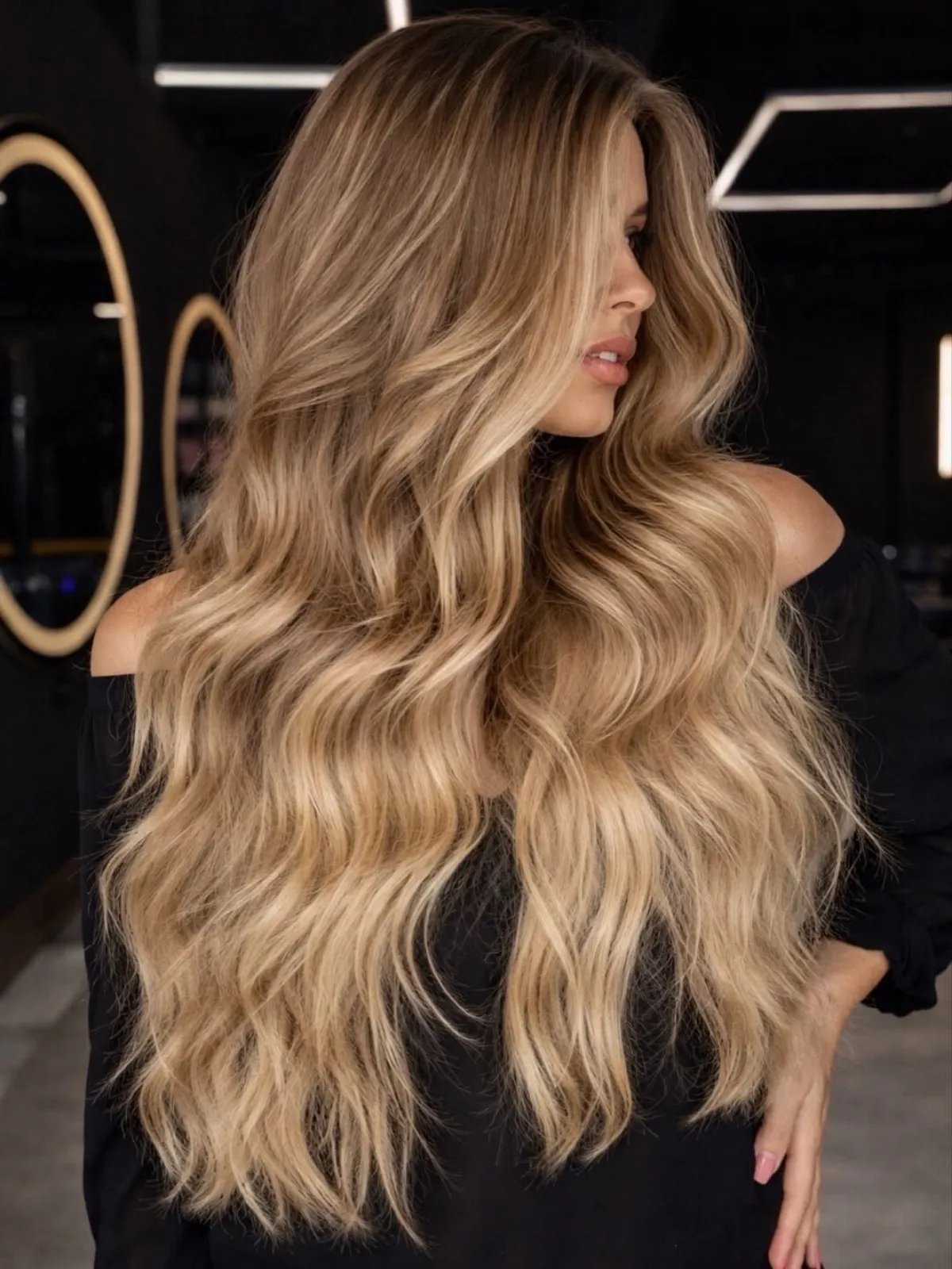 Model with darker butter blonde hair featuring toffee brown tones.