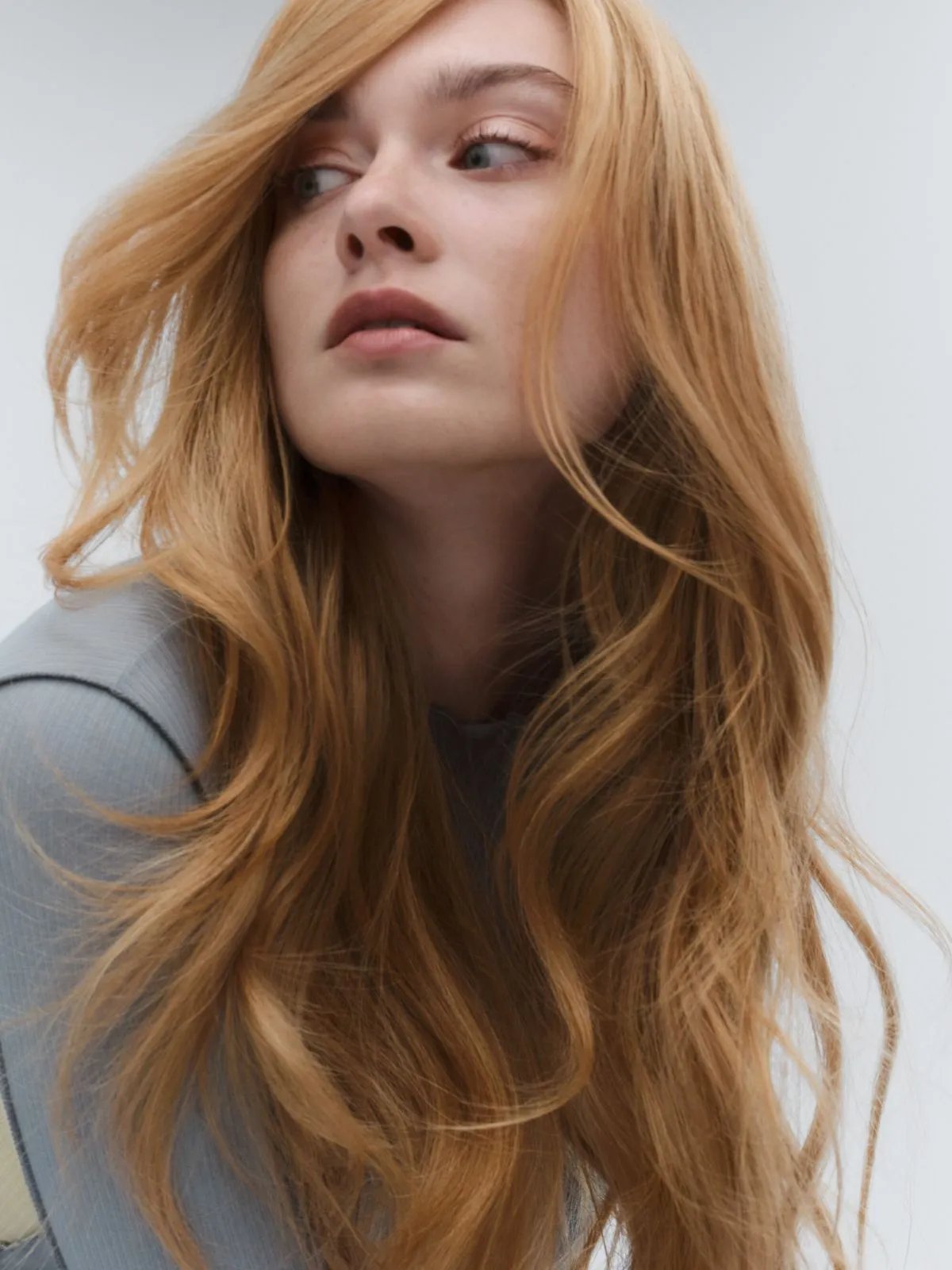 Model with long, loosely curled, golden blonde hair