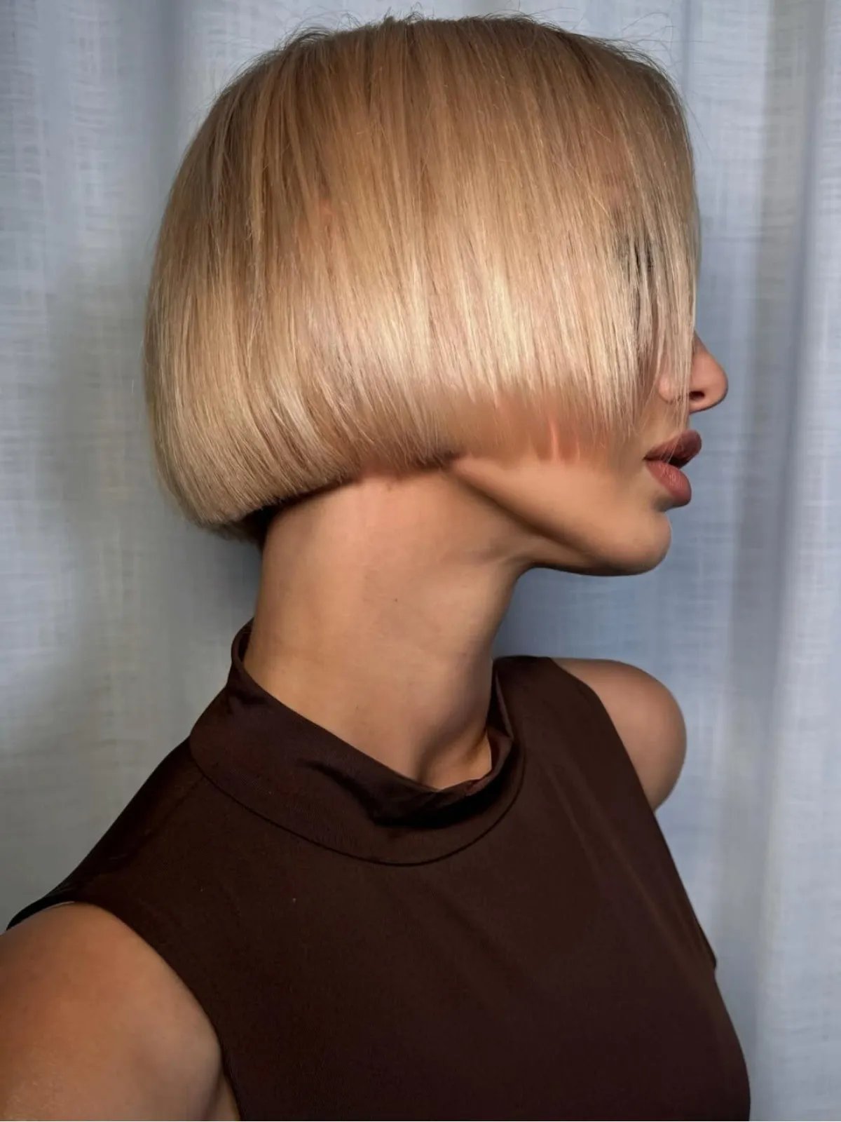 Model with long, ultra-bright buttercream blonde hair.