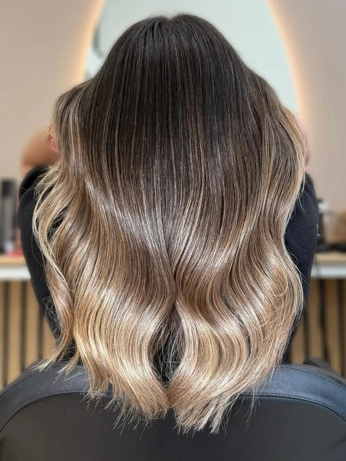 Back of model’s head showing a light brown ombre - dark at the roots and light on the ends.