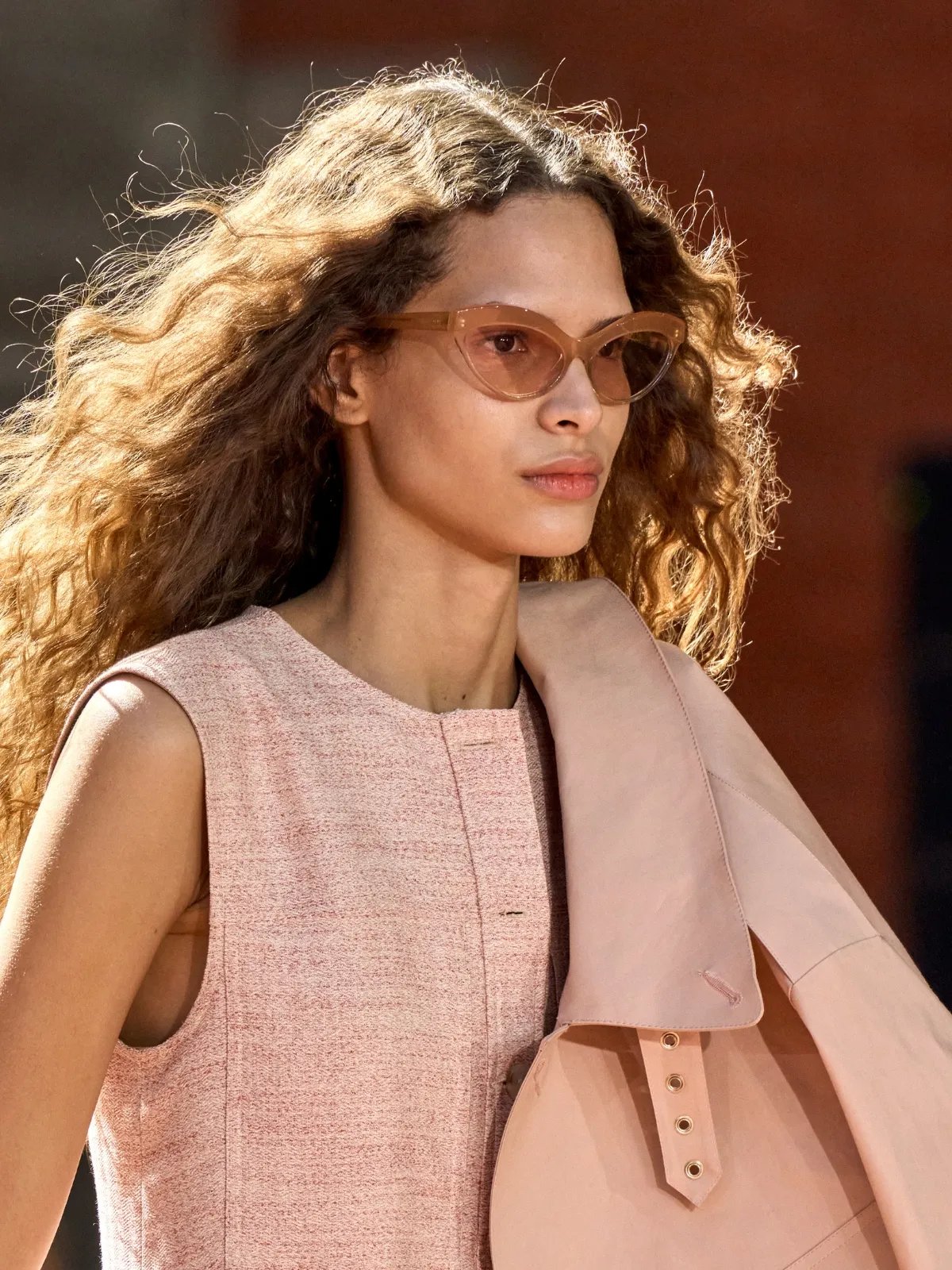 Model with long, brown, wavy hair, walking the Ulla Johnson runway.