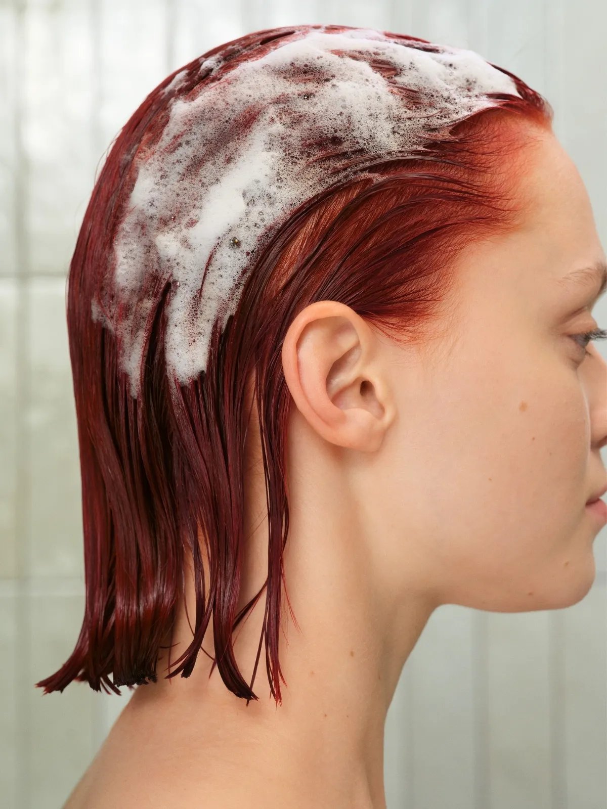 Model with shampoo foam in their hair.