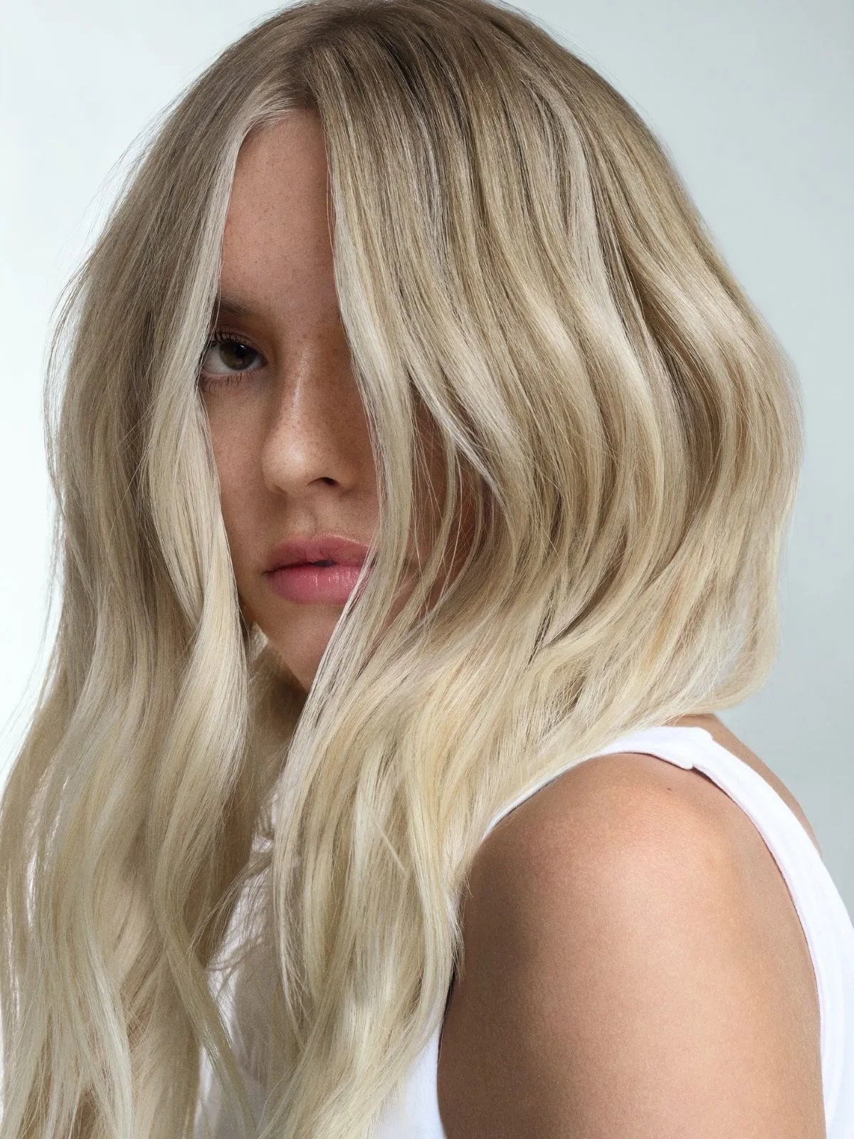 Model with long, loosely tousled, Scandi blonde hair.