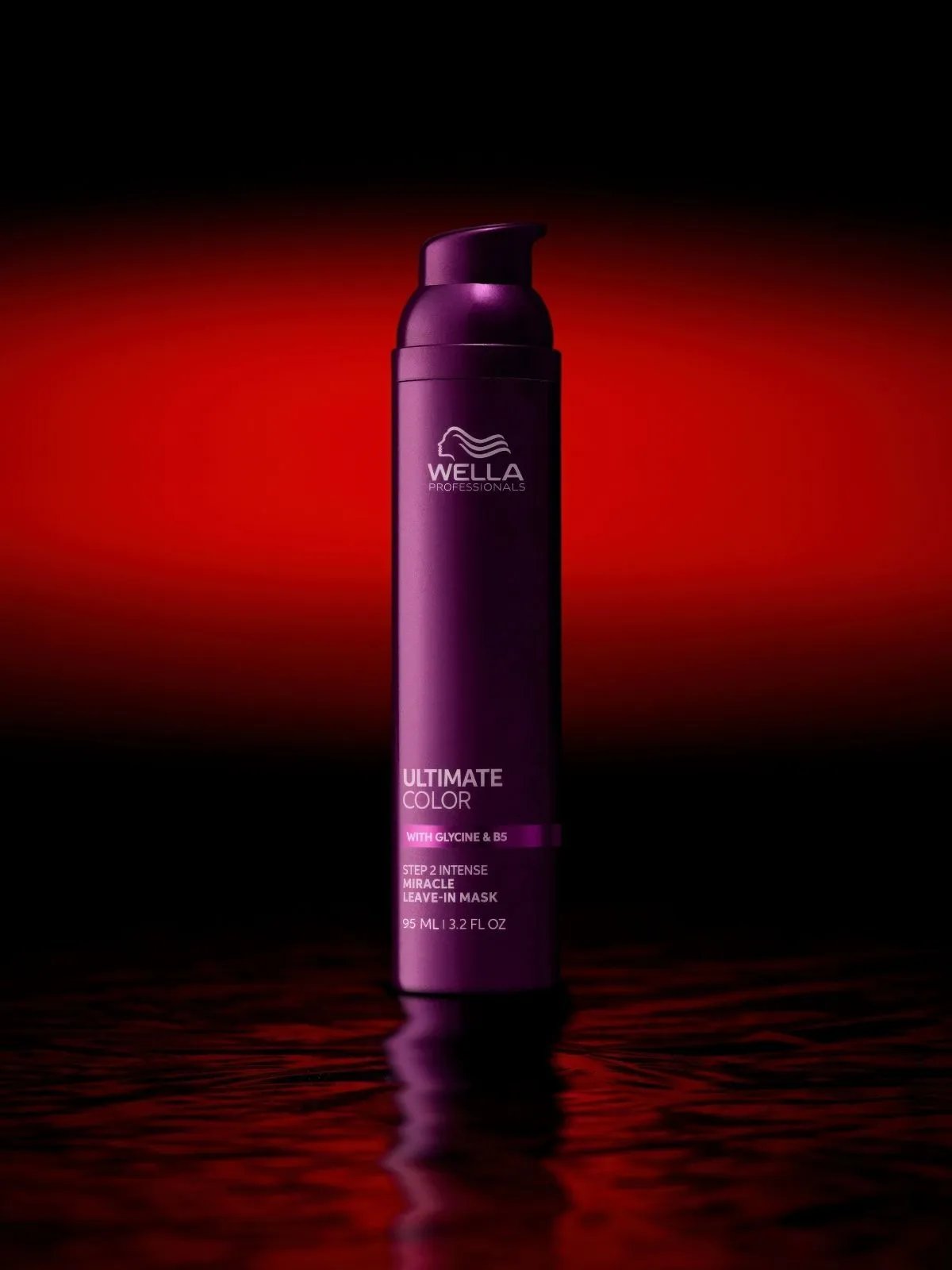 Bottle of ULTIMATE COLOR Miracle Leave-In Mask against a red backdrop.