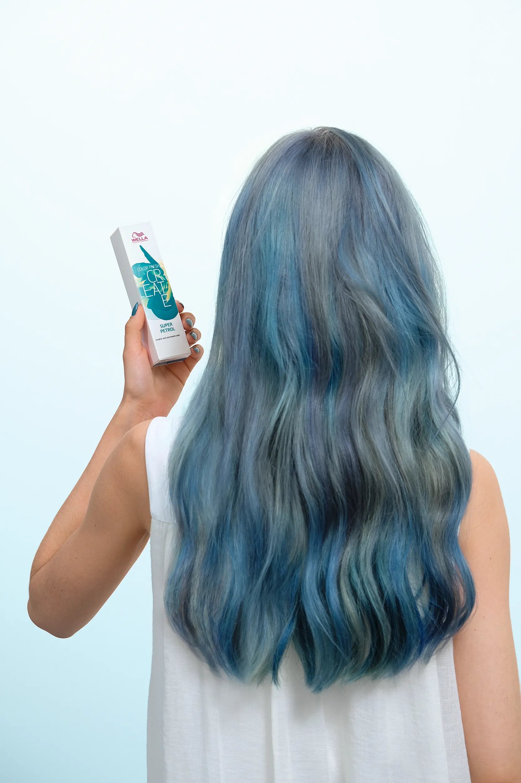 Image of woman with blue hair holding a Color Fresh Create box