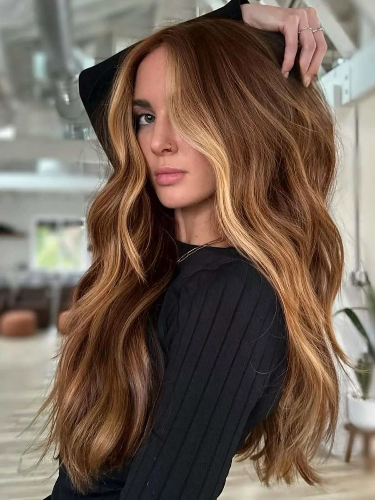 Model with chestnut brown hair featuring bright blonde face-framing highlights.