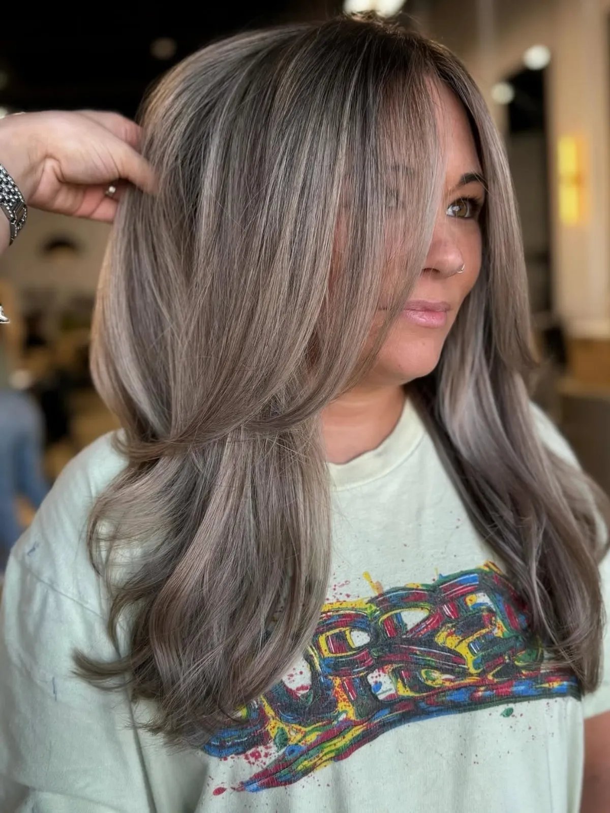 Model with brown hair featuring dark ash blonde highlights.