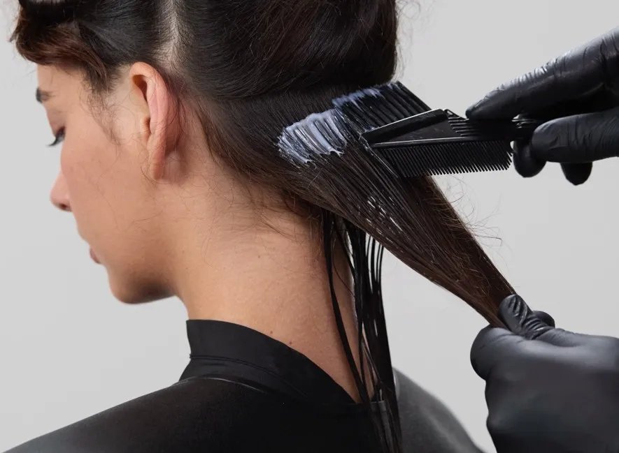 Smoothfiller product is applied to hair with a brush.