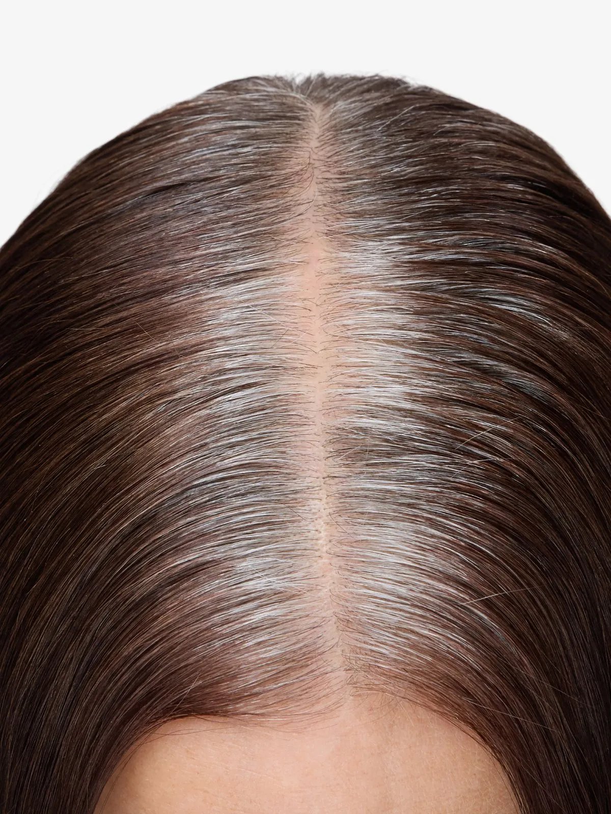 Model with dark brown hair and visible grey roots.