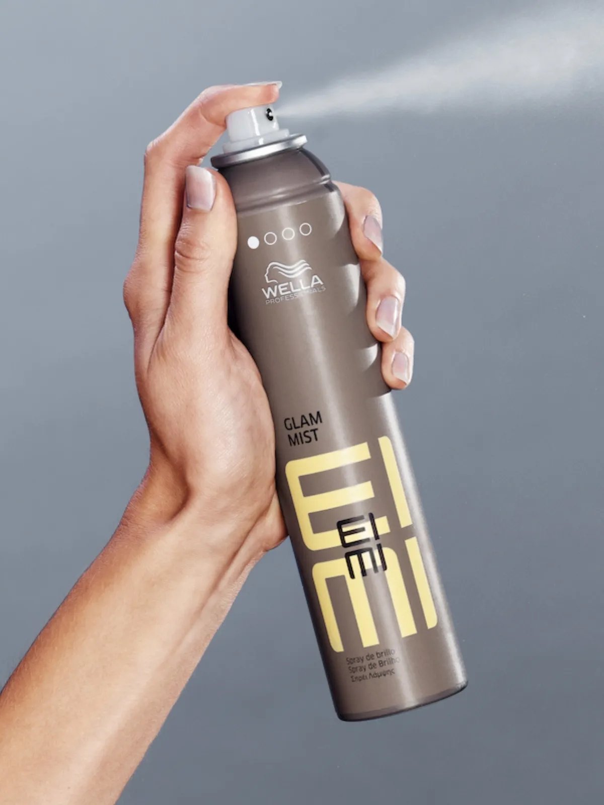 Model sprays EIMI Glam Mist.