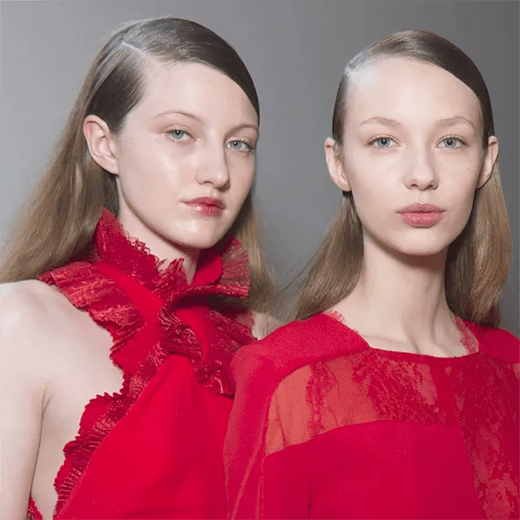 Two blonde women with wet-look hair