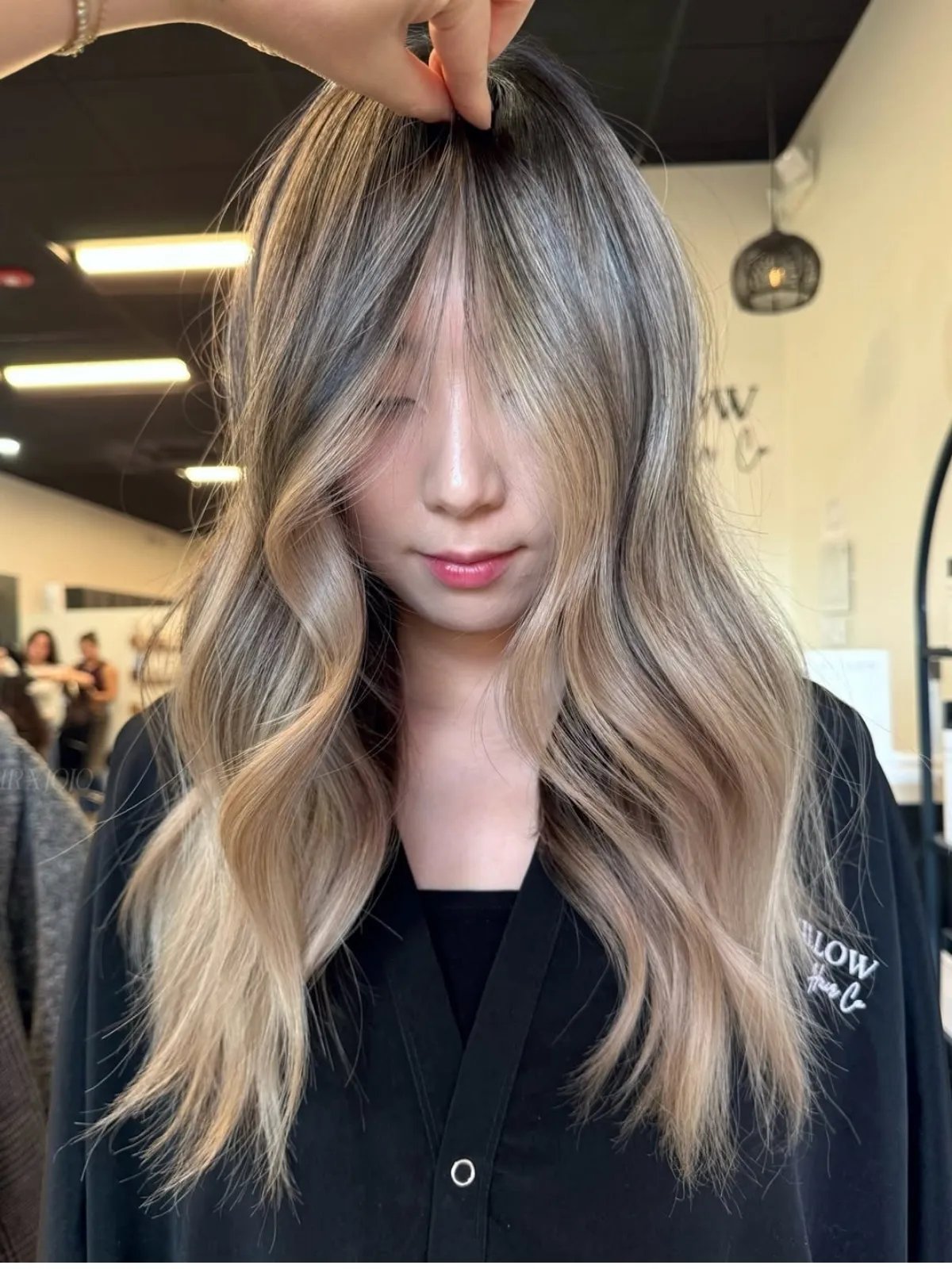 Model with light beige blonde highlights through loosely tousled hair.
