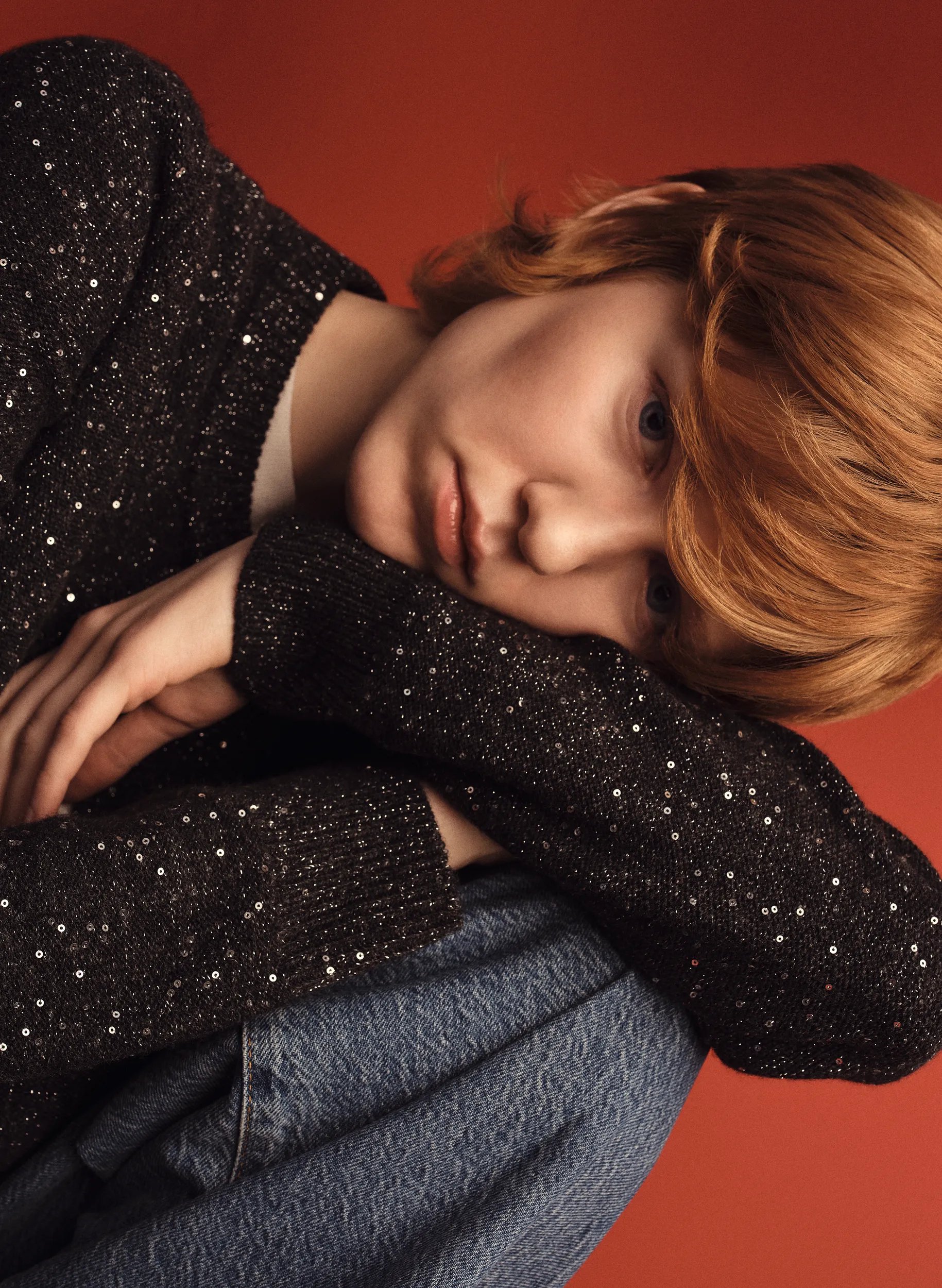 Model with short red hair looking at the camera
