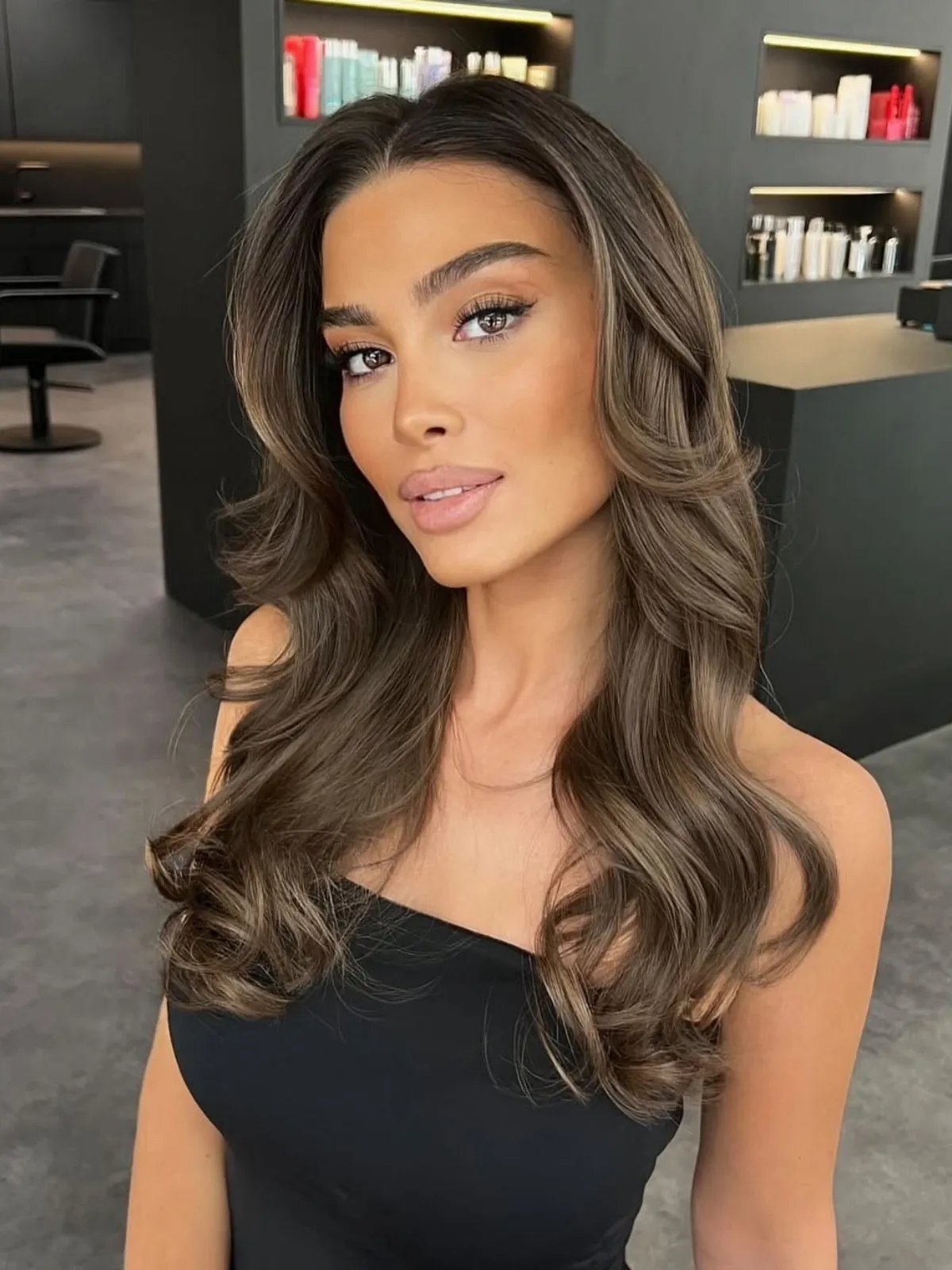Ashy chocolate brown hair color with cool undertones and soft balayage highlights.