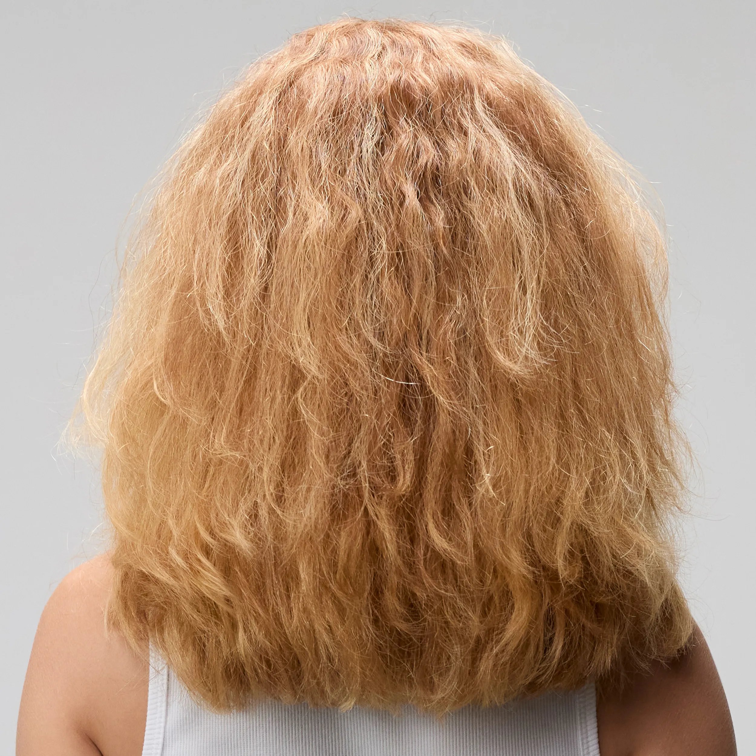 Before and after showing model’s long, blonde, frizzy hair looking smooth and glossy after a SmoothFiller service.