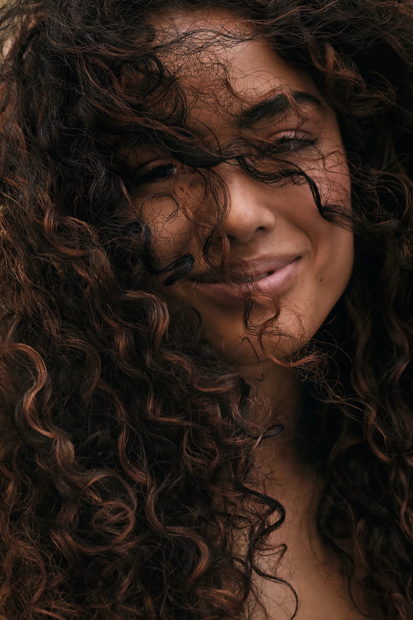Model with curly dark brown hair
