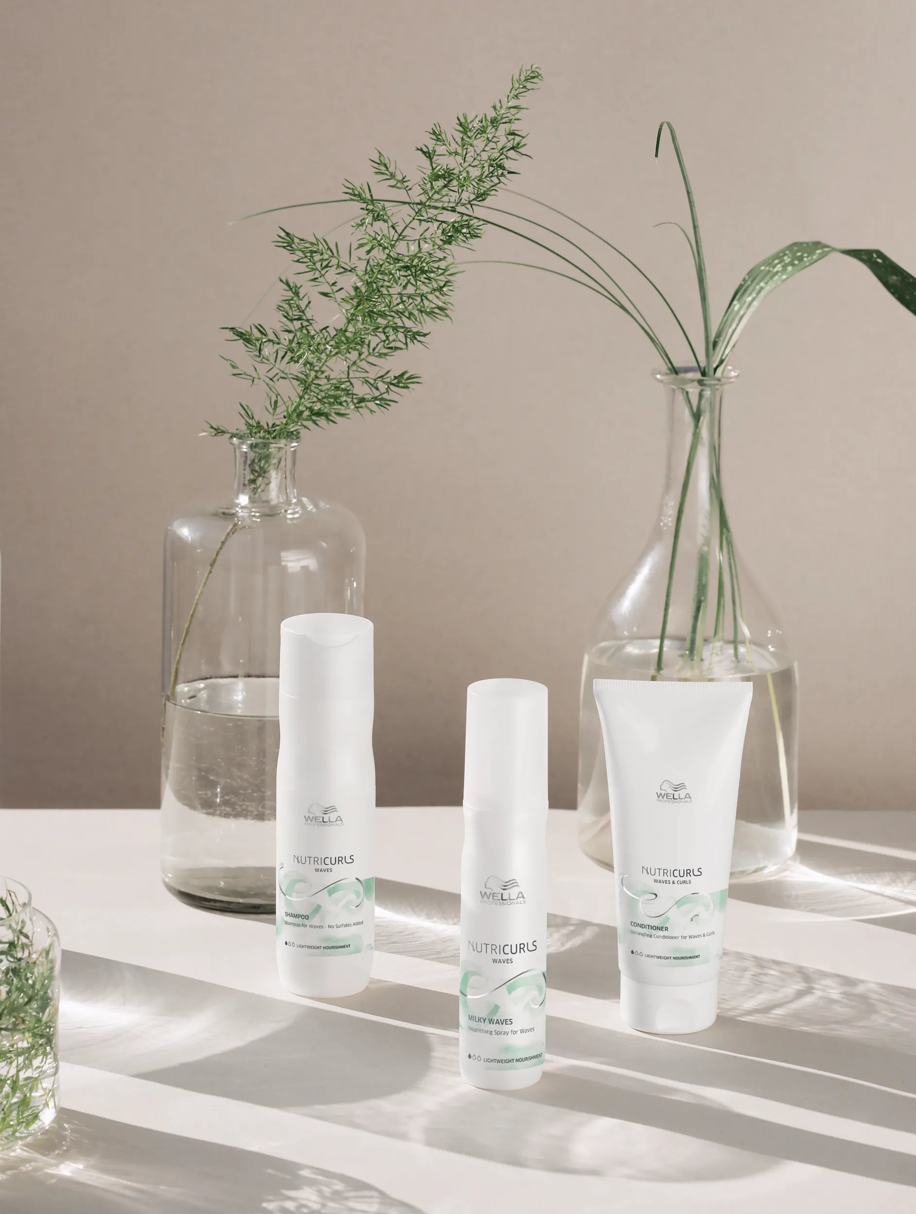 Nutricurls Collection on a white table with plants