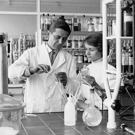 Black and white photo of two scientists in a lab. 
