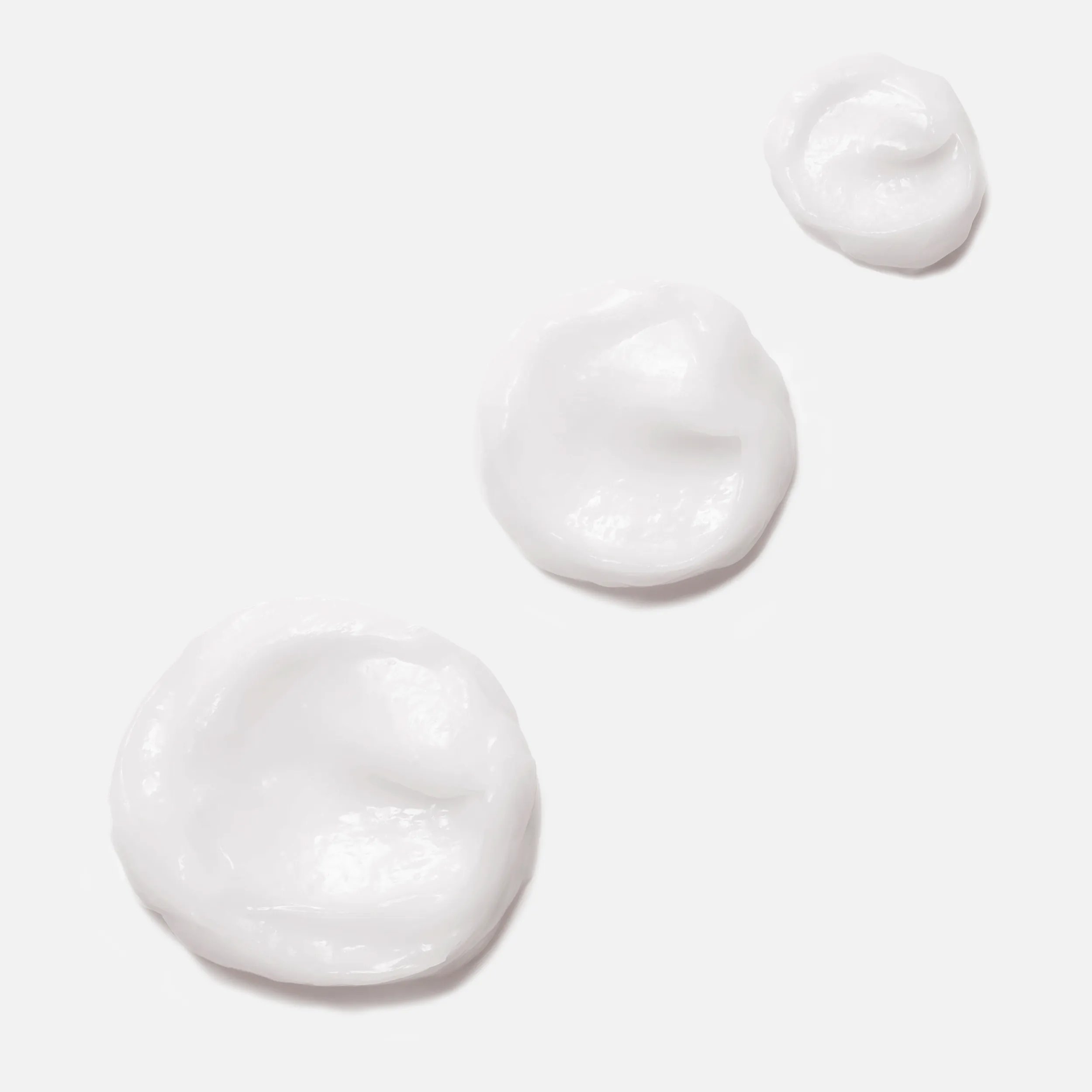 Close-up photograph of 3 circular blobs of Invigo Nutri-Enrich Mask on a white background, with text saying 'oleic acid & panthenol, help to provide moisturization & nourishment'