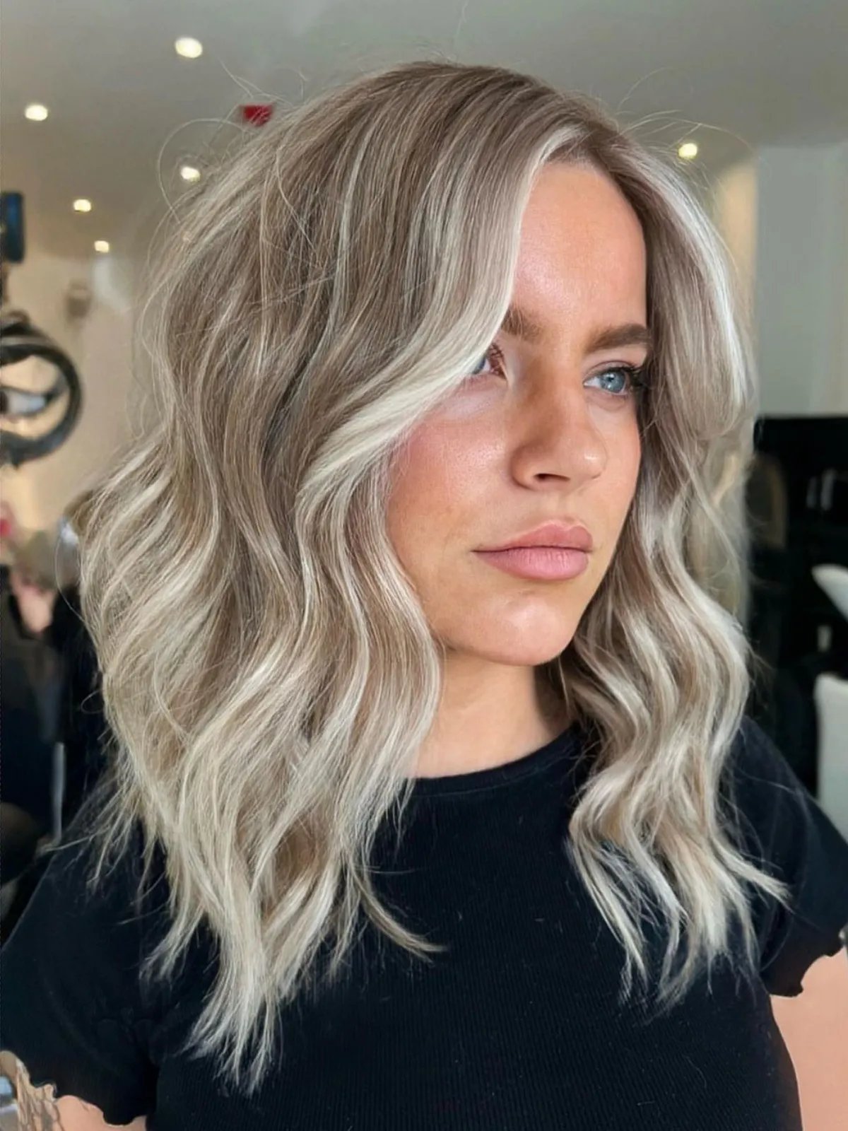 Model with a mix of platinum blonde and ash blonde highlights.