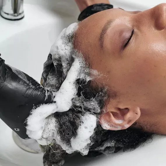 Model’s hair is washed at the sink.