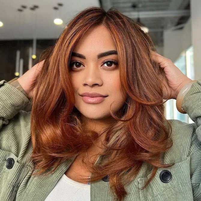 Model with long, glossy, copper bronze hair. 