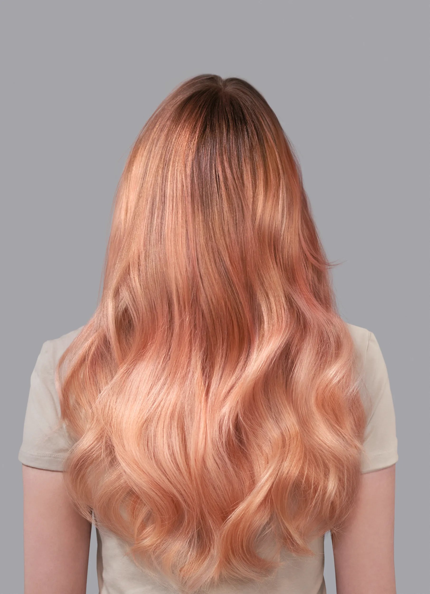 Back view of woman with long coral hair colored with Wella Color Fresh Mask.