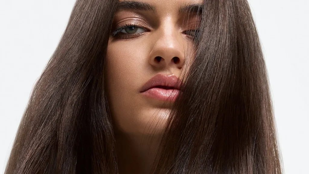 Model with long, glossy, smooth hair after a SmoothFiller™ service.