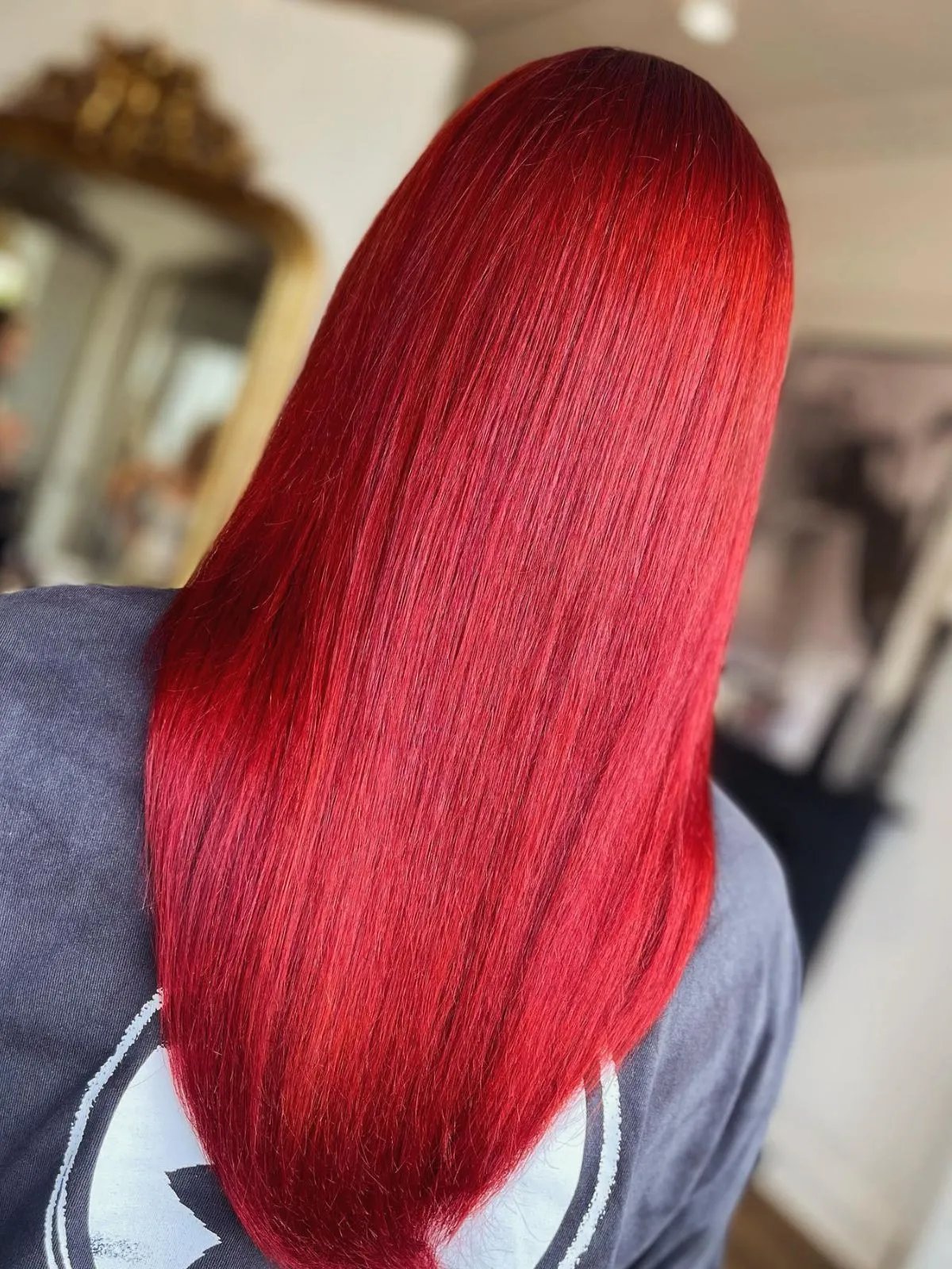 Model with velvety red hair, styled straight and sleek.