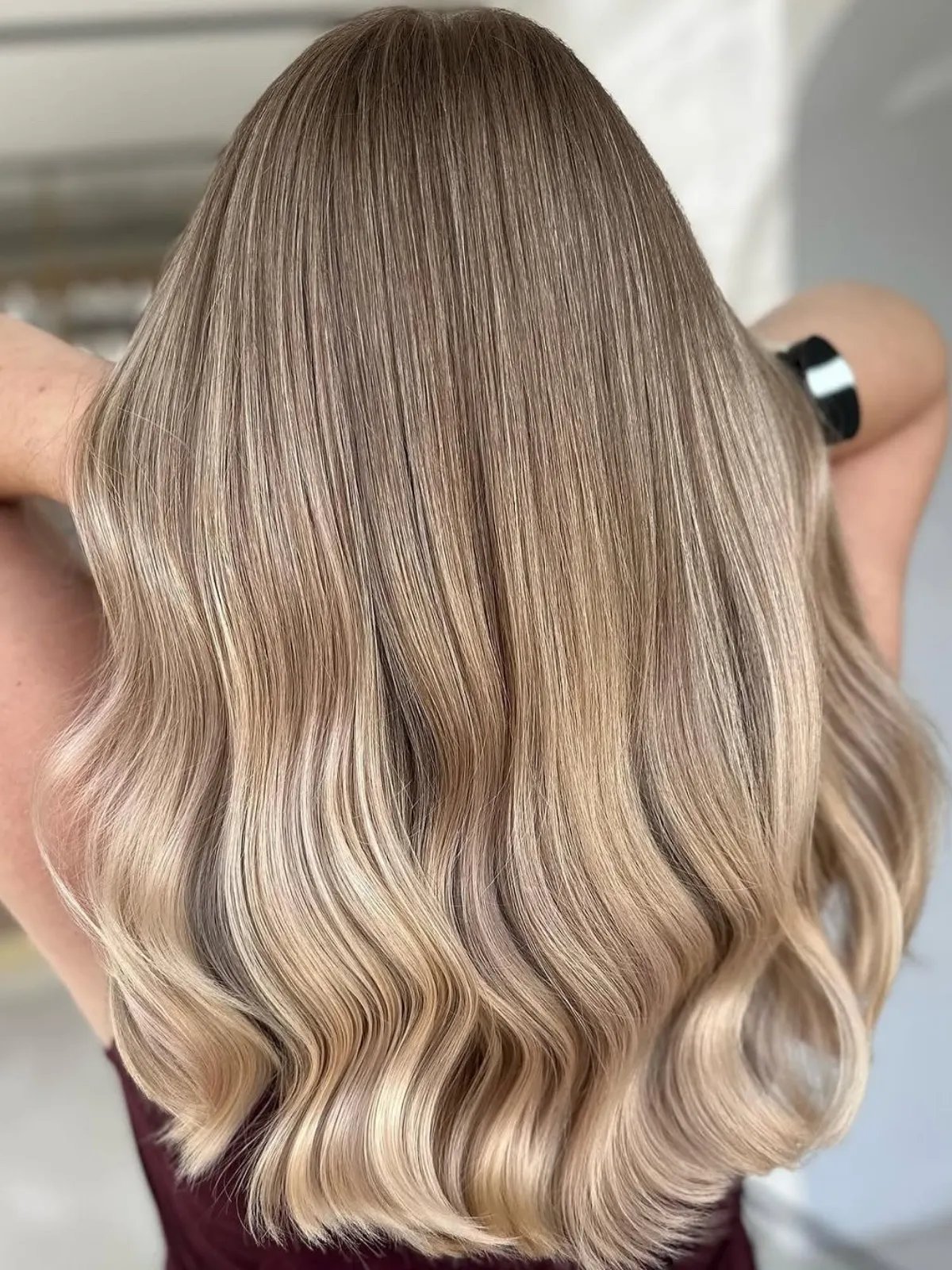 Back of model’s head with long, beige blonde hair.