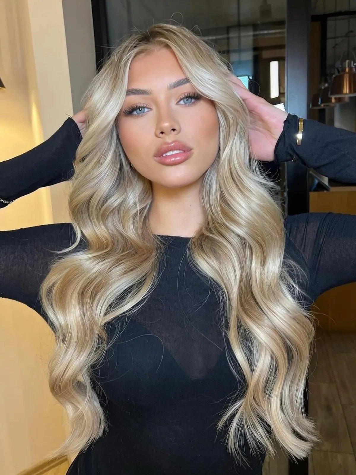 Model with long, wavy, golden pearl blonde hair.